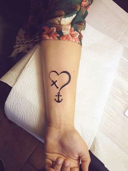 Meanings of Small Tattoo Ideas and Where to Get Them 16 heart with an arrow tattooed on her right hand