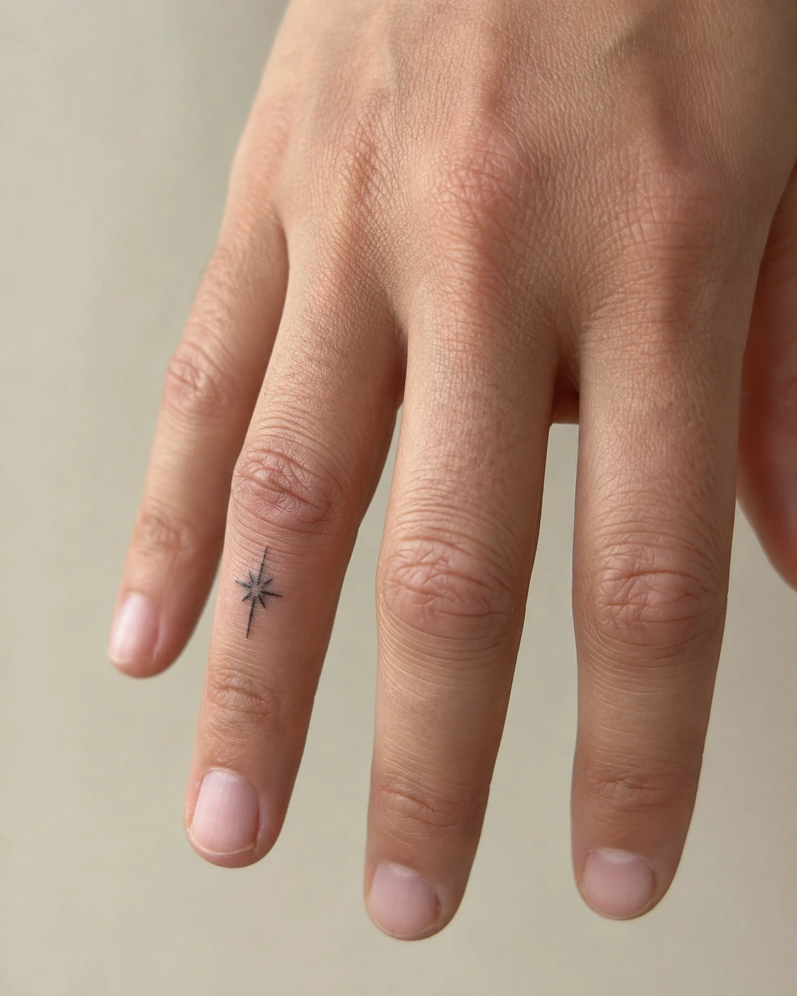 Healed simple finger tattoo with clear linework