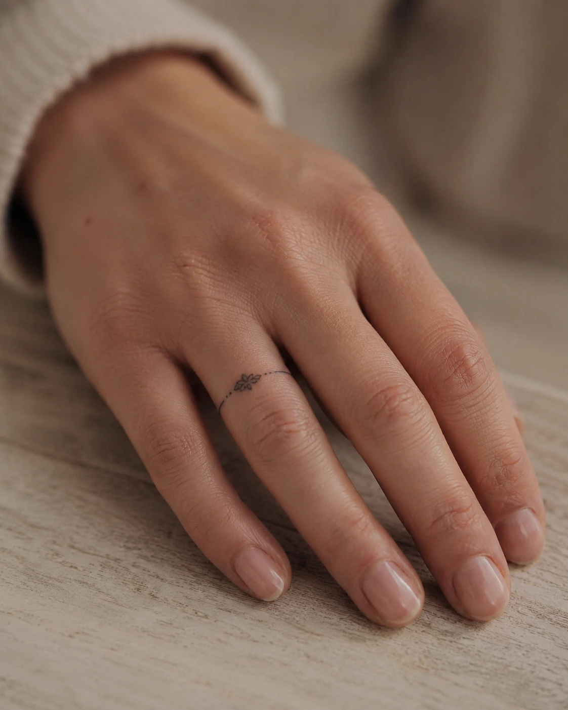 Minimal ring-style finger tattoo